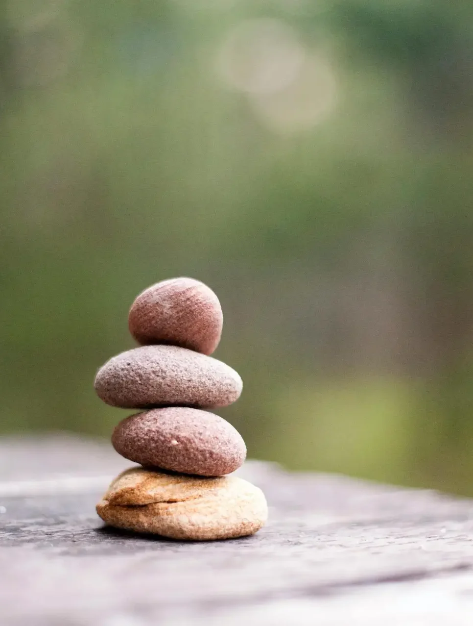 Balance and tranquility embodied by stacked stones in a natural outdoor setting.